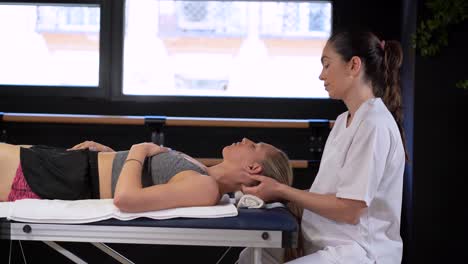 female therapist massaging head of patient