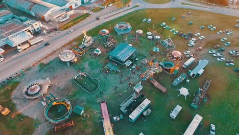 aerial drone footage of a small town carnival at the sunset