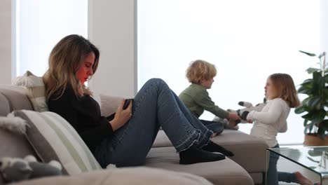 sad children near mother browsing tablet