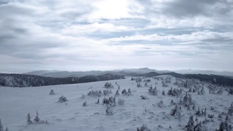 flying towards several kite skiers skiing on a mountain in winter - aerial view