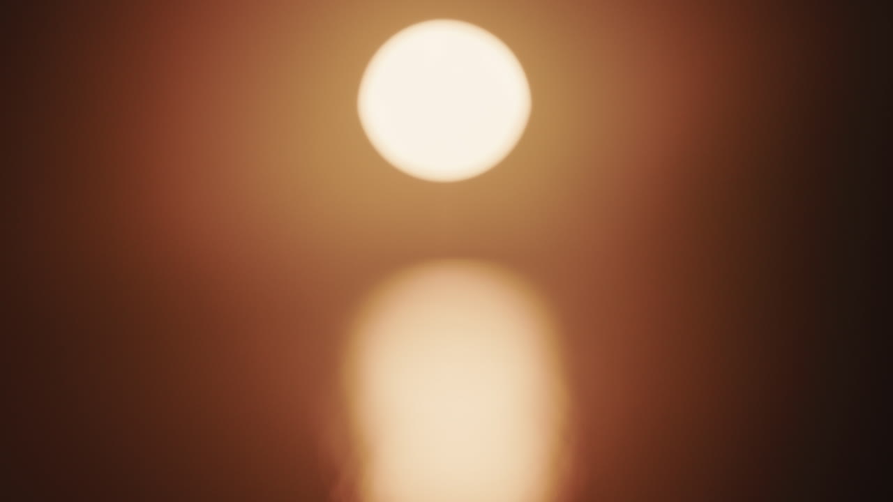 Abstract, out of focus shot of the sun and its reflection on the sea