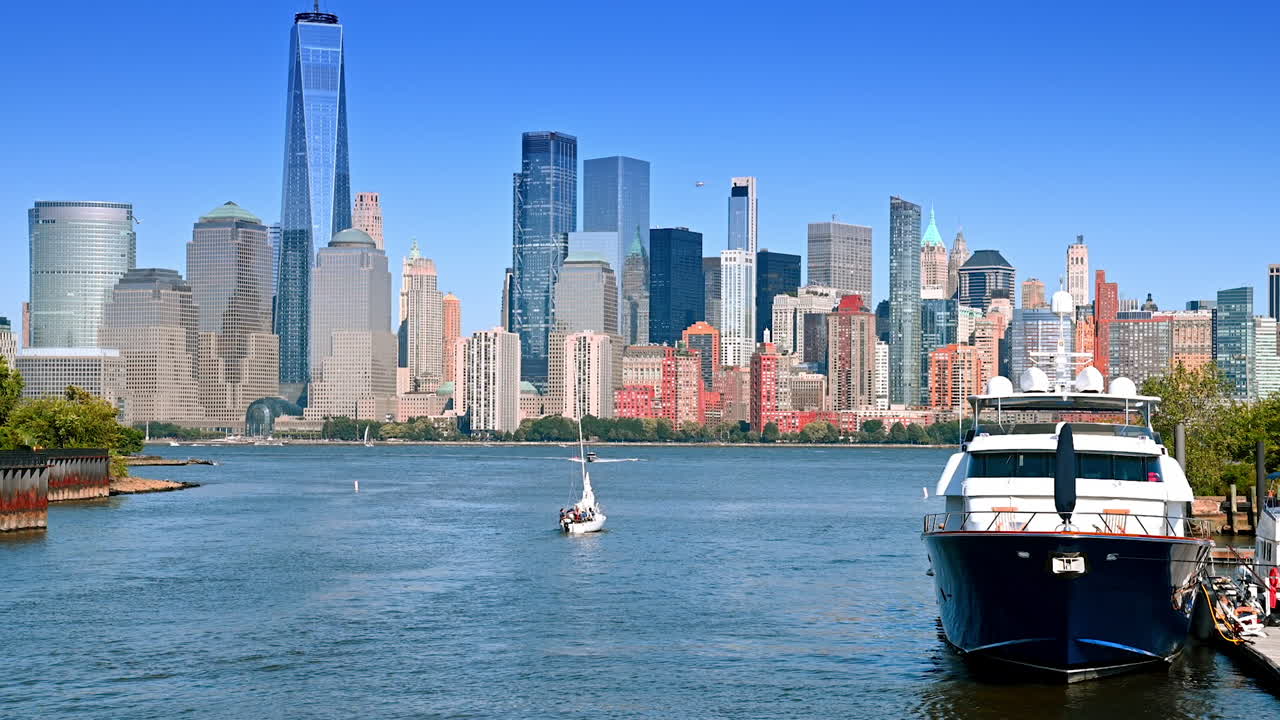 Yachts and boats on the waterscape of the Hudson River on sunny day. View on Manhattan from the side of Jersey