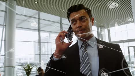 Animation-of-network-of-connections-over-caucasian-businessman-talking-on-smartphone