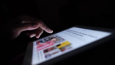 Person using a tablet at night