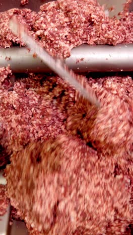 meat grinding process in industrial setting
