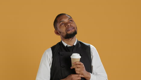 Restaurant-waiter-enjoying-a-cup-of-coffee-drink-on-his-work-break