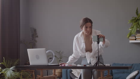 vlogger woman preparing her recording and broadcasting equipment prior to streaming