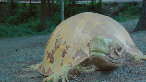 Circling-a-massive-rusted-steel-and-iron-tortoise-in-a-North-Carolina-park