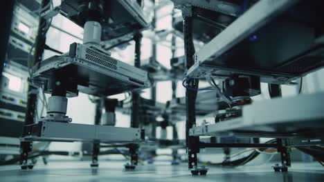explore a cutting-edge robotics facility where automated systems work seamlessly. watch robotic machines maneuver and organize components efficiently in a controlled environment.
