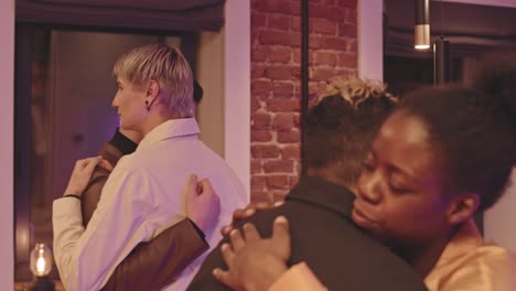 gay and lesbian couple slow dancing at party