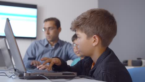 schoolboys having fun during computer science class