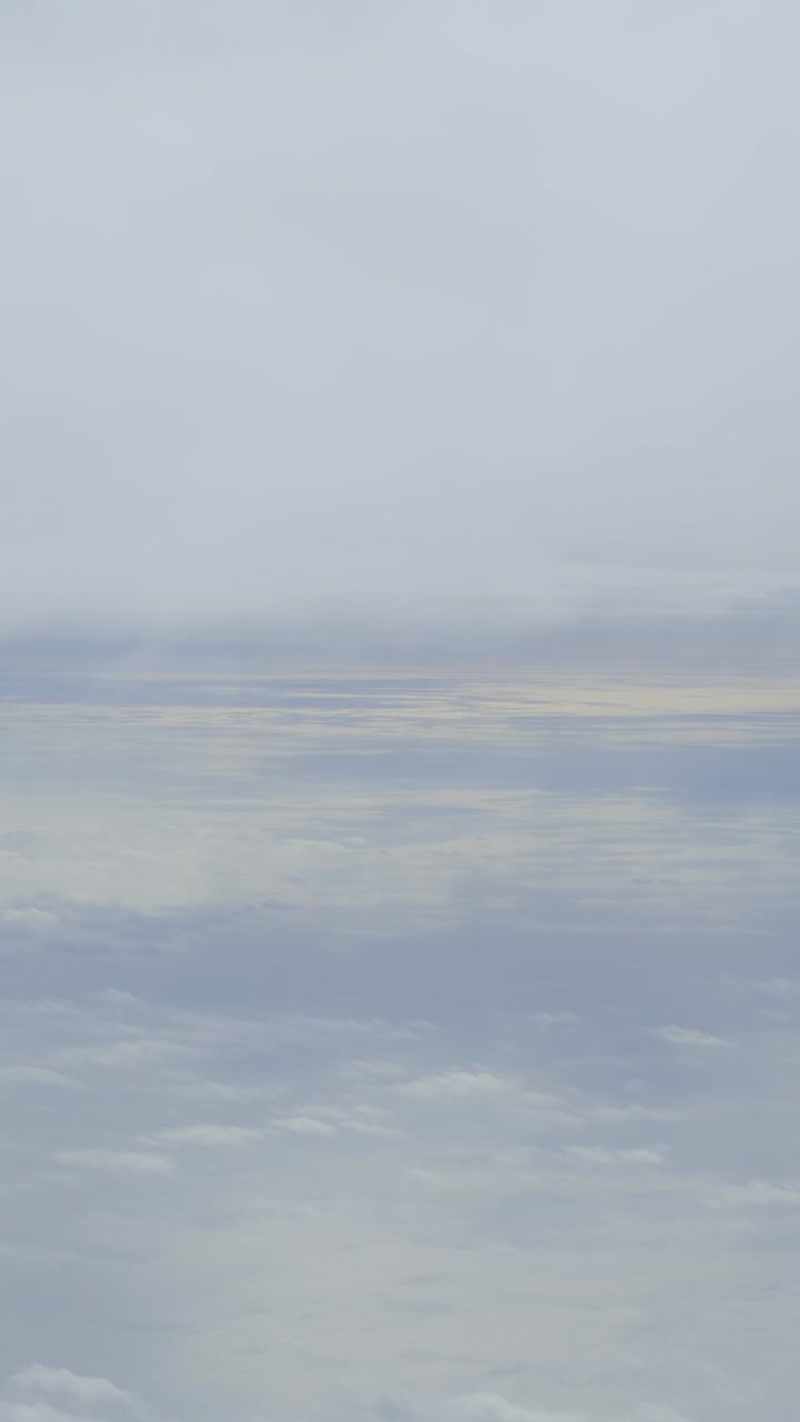 Serene landscape with calm waters under a soft, cloudy sky