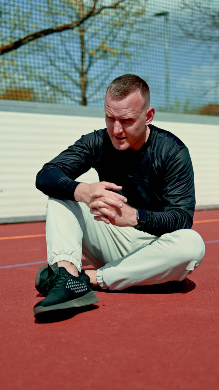 Man young strong athlete doing push-ups exercise on sports ground. Tall athlete fitness trainer guy training workout bodybuilding outdoors motivation