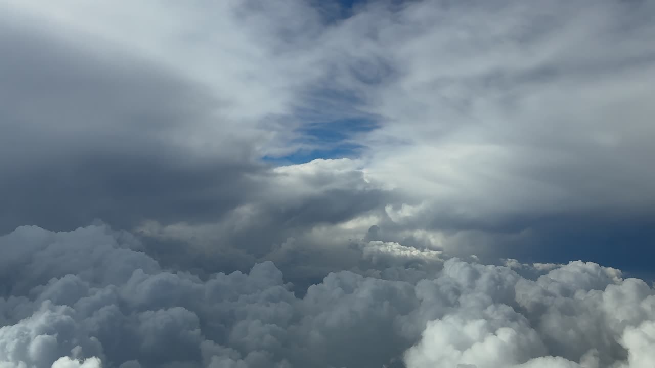 An immersive pilot’s view from a jet cockpit while flying through white cottony storm clouds looking for a path to avoid bad weather. Ultra-realistic 4K