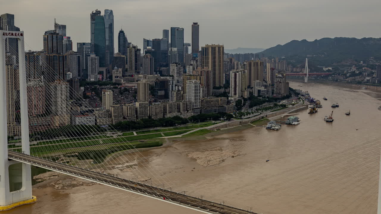 Timelapse of the amazing Chongqing cyberpunk city skyline from a high vantage point wirh the yangtze river