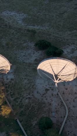 abandoned satellite dishes in a rural landscape