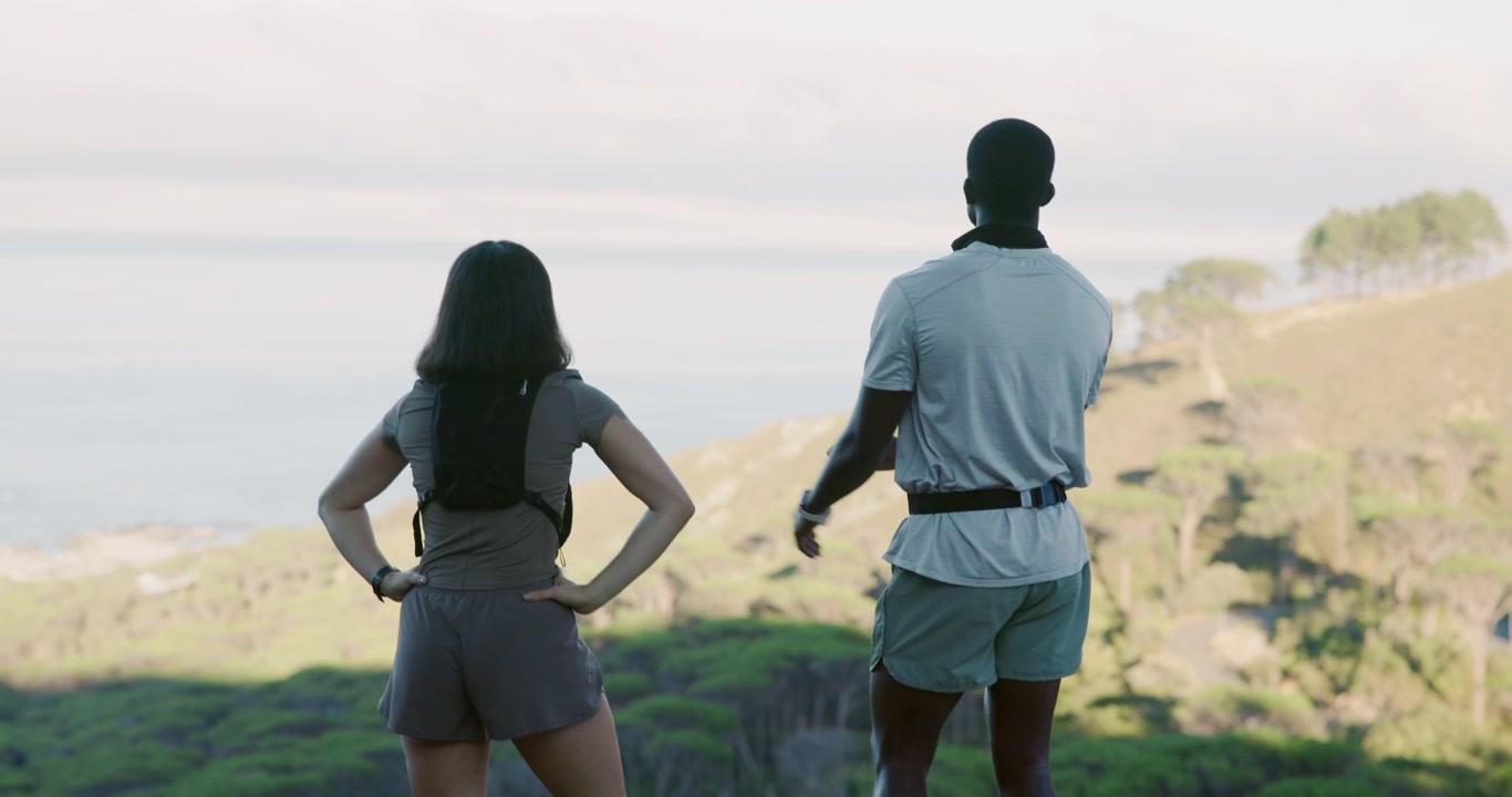 Active Couple High-Fiving and Enjoying Scenic Coastal View