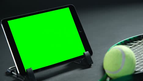 tennis balls, racket and digital tablet in studio 4k