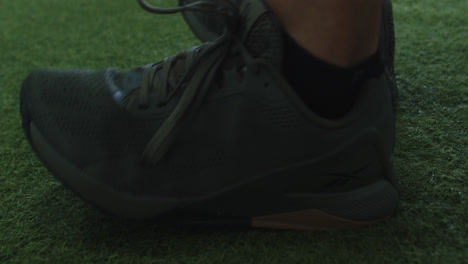 amazing close-up of a man's feet in the gym with sports shoes warming up for his workout