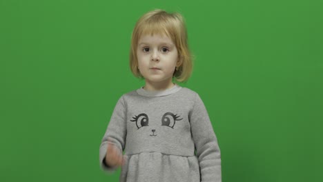 Kid-girl-making-a-fly-kisses-on-a-Green-Screen,-Chroma-Key