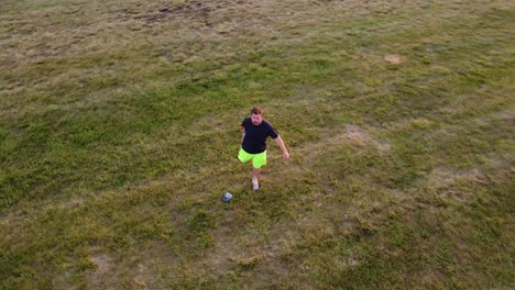 drone footage circling and raising watching a man stretch and exercise in a park between baseball diamonds