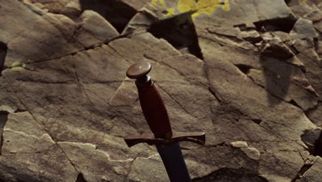 excalibur sword in rocky stone at sunset