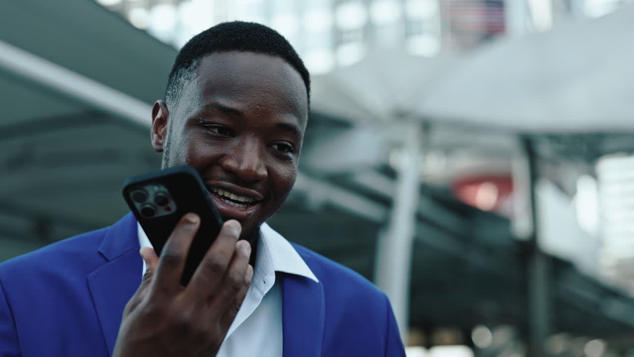 Young Black Man Using Smartphone in Urban Setting