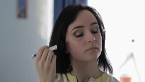 young, pretty woman in pajamas near mirror. beauty and makeup concept