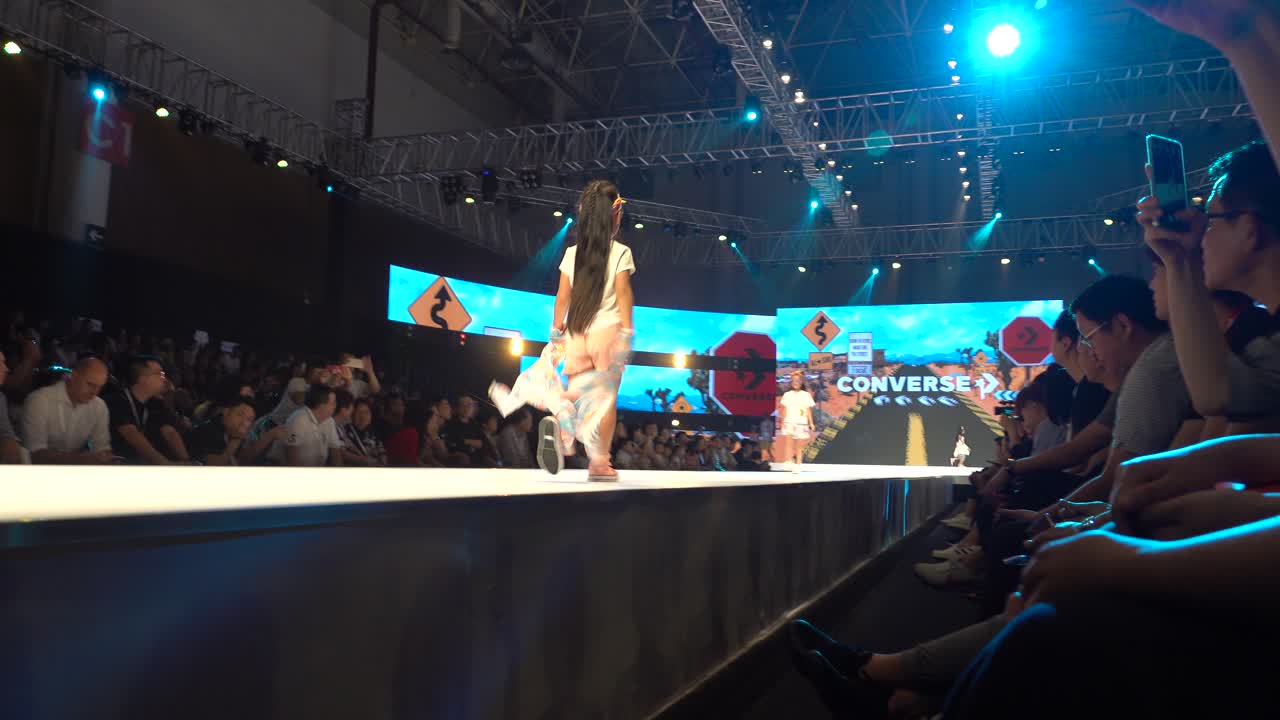 Young Girl Models on Runway at Fashion Show