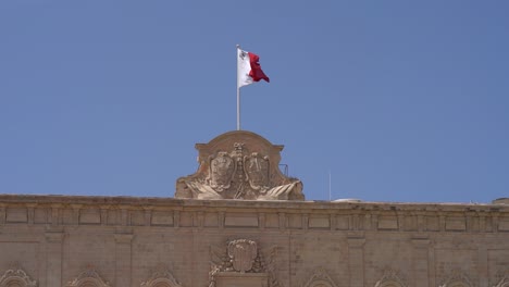 slow motion shot of the maltese flag fluttering in the wind, malta