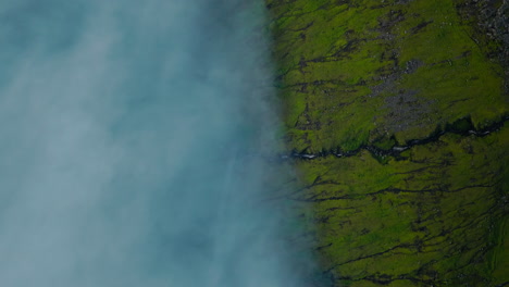 Vibrant Green Landscape Meeting Hazy Blue Waters