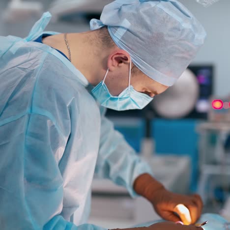real operating theater room. surgeon together with female assistant performing an operation with medical tools in clinic. medical concept.