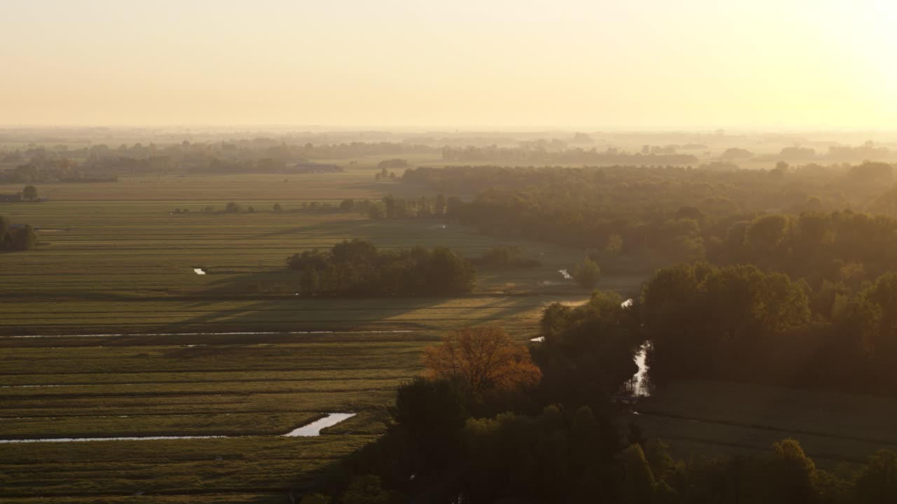 Aerial view over farmlands in Krimpenerwaard, Netherlands, lit by dusk sunlight