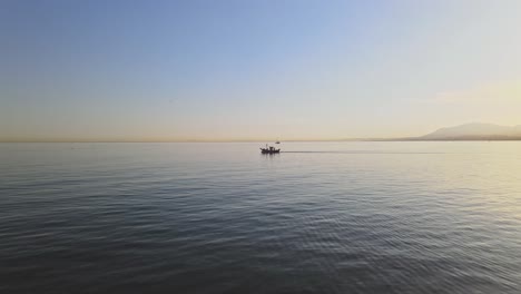 aerial shot of boat on the calm ocean with slight tilt upwards