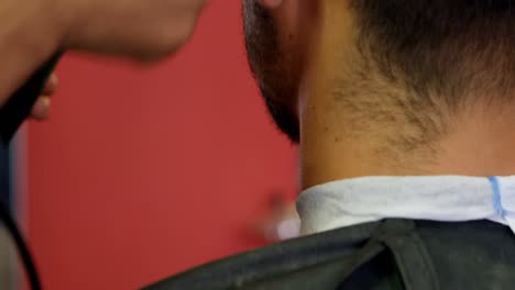 man getting his hair trimmed with trimmer 4k