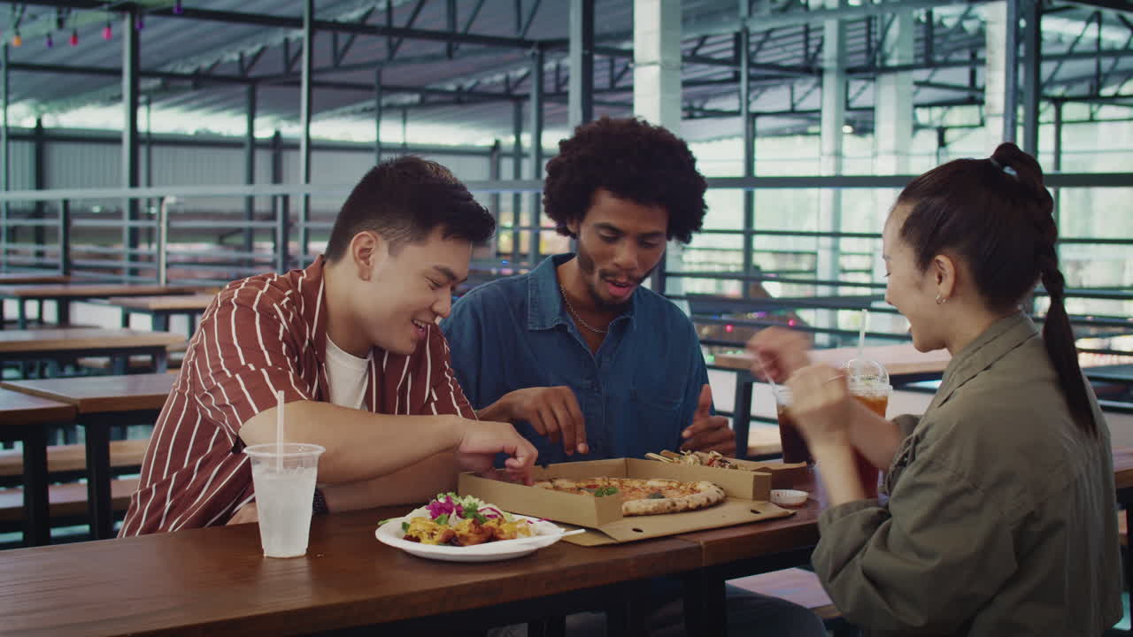 Multiethnic People Enjoying Tasty Pizza at Street Food Cafe