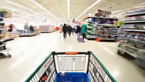 a view from a shopping cart in a crowded supermarket aisle