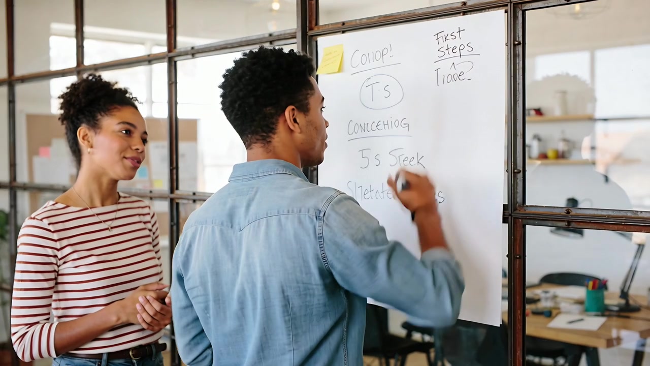 Writing man in denim shirt following striped-top woman at glass wall, listing on pad with marker