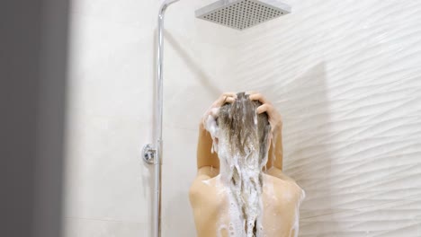 pretty asian young woman applying facial moisturizer cream after taking a shower at home. beauty and skincare concept.