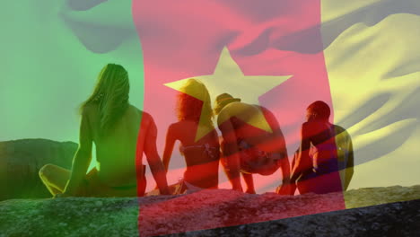 Sitting on rocks, people with Cameroon flag overlay, enjoying sunny day outdoors