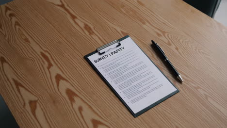 survey on clipboard on wooden table