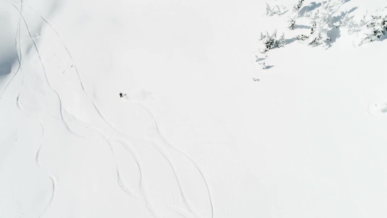 Skier skiing on a snow capped mountain 4k