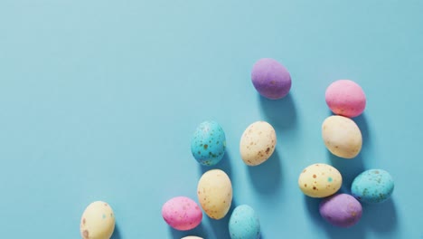 video of decorated colorful easter eggs on a blue surface