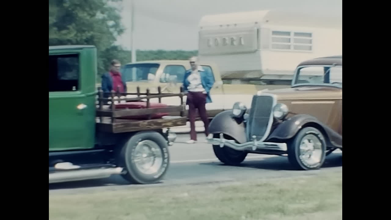 Classic Truck and Motorcycle in 1970s American Car Show. CIRCA USA - 1970s: An iconic truck effortlessly shares the road with a sleek motorcycle in this vintage photograph captured during a vibrant 1970s car show in the USA.