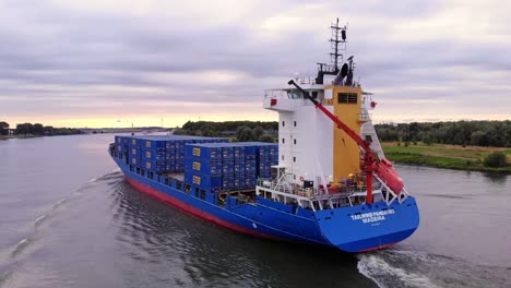 close shot of tailwind panda ship leaving behind wave trail in oude maas river, netherlands