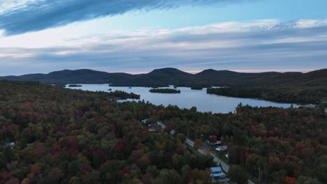 fall foliage surrounding blue mountain lake at dusk in hamilton county, new york