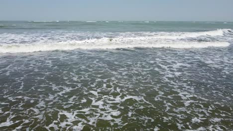 aerial side track view of cape point, bakau - the gambia, cinematic sliding right low over the sea