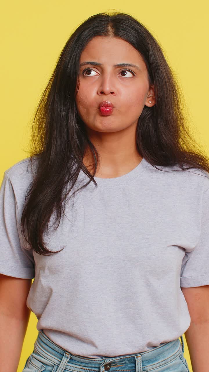 Funny comical playful woman making fish grimace pout lips smooching choking dumb idiotic expression