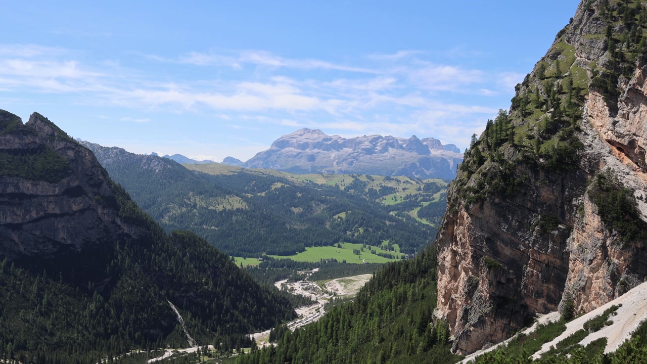 Climbing Piz dles Cunturines mountain in Dolomites, view from the mountain towards the valley