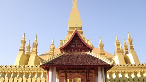 little buddhist temple in front of pha that luang golden stupa temple in vientiane, laos